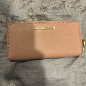 Michael Kors nude beige tan leather zipper, gold hardware. Very good condition!